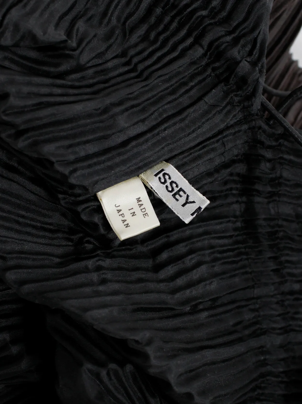 Issey Miyake dark brown drawstring backpack with fine pressed pleats